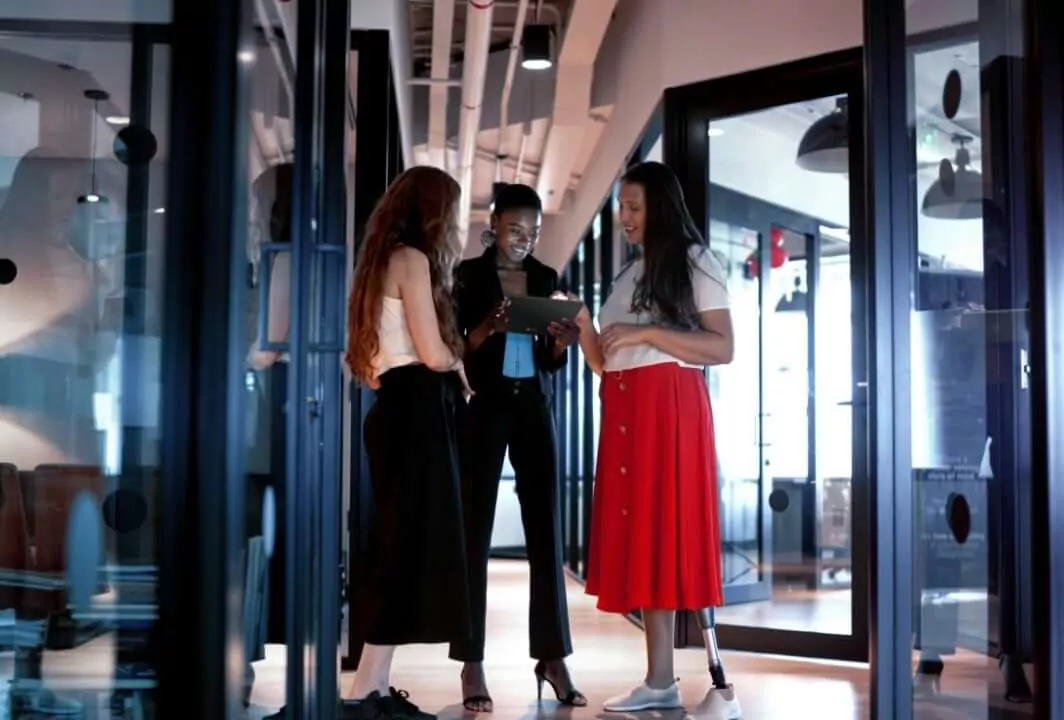 Three women in the office with a tablet