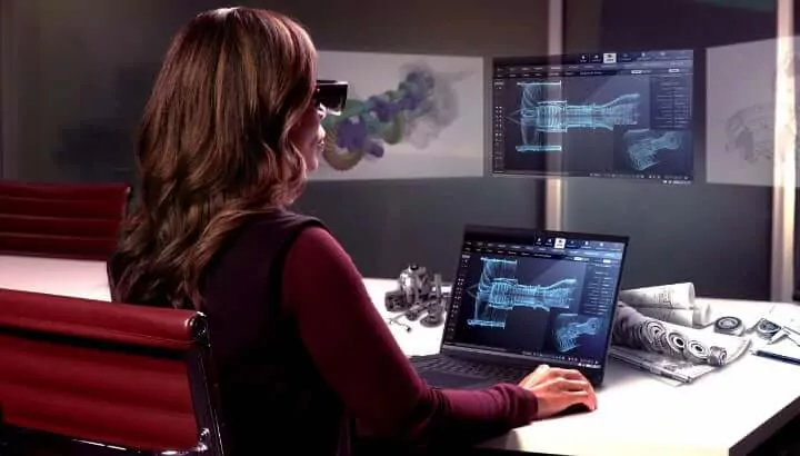 Woman in VR glasses and laptop
